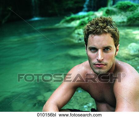 Stock Image - portrait of young man in tropical environment. Fotosearch