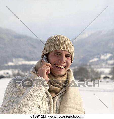 portrait of young man in winter clothes with cellular phone View Large Photo Image Stock Image - portrait of young man in winter clothes with cellular phone. Fotosearch