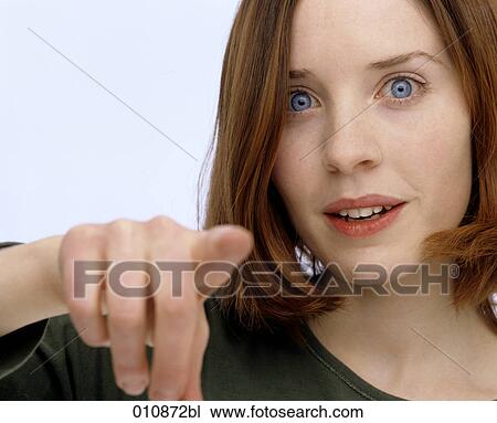 Portrait of young woman pointing towards camera View Large Photo Image Stock Image - Portrait of young woman pointing towards camera. Fotosearch