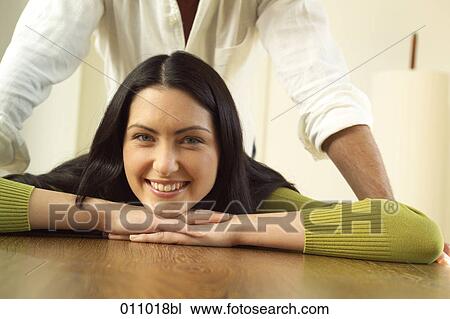 Portrait of young woman with man standing behind her View Large Photo Image Stock Image - Portrait of young woman with man standing behind her. Fotosearch