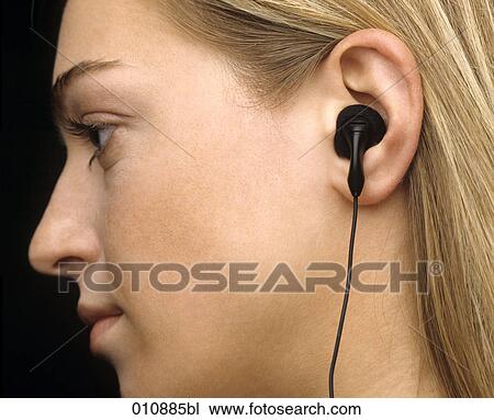Profile of blonde woman with earphone View Large Photo Image Stock Image - Profile of blonde woman with earphone. Fotosearch