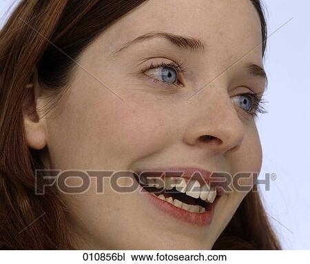 Profile of smiling young woman with blue eyes View Large Photo Image Stock Image - Profile of smiling young woman with blue eyes. Fotosearch