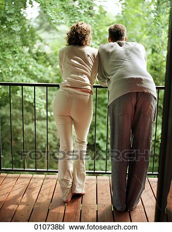 rear view of couple standing on balcony View Large Photo Image Stock Image - rear view of couple standing on balcony. Fotosearch