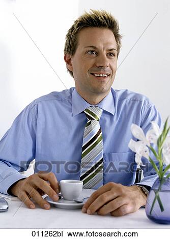 smiling businessman having a cup of coffee View Large Photo Image Stock Image - smiling businessman having a cup of coffee. Fotosearch