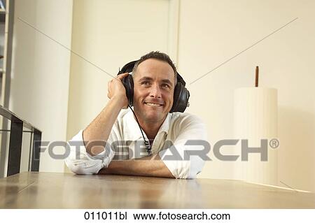 Smiling young man with headphones View Large Photo Image Stock Image - Smiling young man with headphones. Fotosearch