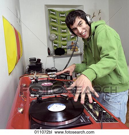 Teenage boy with headphones using professional record player View Large Photo Image Stock Image - Teenage boy with headphones using professional record player. Fotosearch
