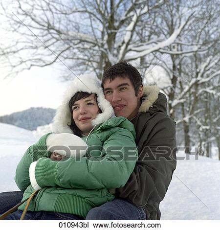 Stock Image - teenage couple enjoying a day out in the snow. Fotosearch