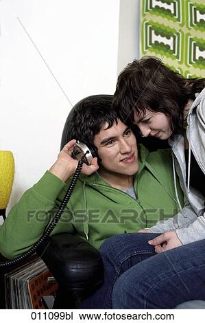 Stock Image - Teenage couple listening to music together. Fotosearch