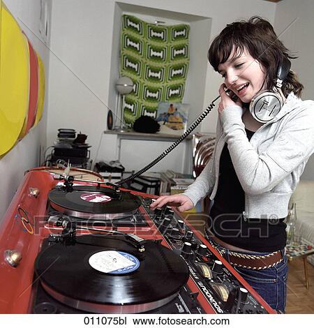 Teenage girl checking record at party View Large Photo Image Stock Image - Teenage girl checking record at party. Fotosearch