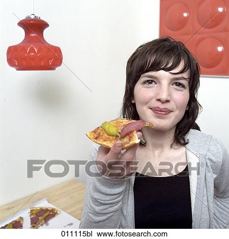 Teenage girl enjoying a piece of pizza View Large Photo Image Stock Image - Teenage girl enjoying a piece of pizza. Fotosearch