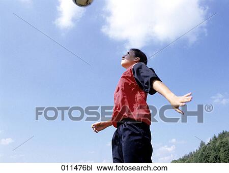 teenage girl in football dress doing a header View Large Photo Image Stock Image - teenage girl in football dress doing a header. Fotosearch