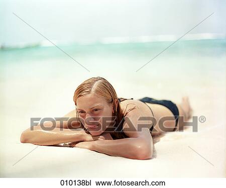 teenage girl relaxing in the sand, sunbathing View Large Photo Image Stock Image - teenage girl relaxing in the sand, sunbathing. Fotosearch