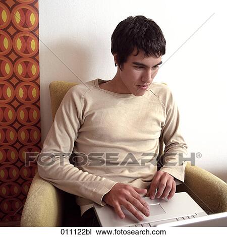 Teenager working with laptop computer View Large Photo Image Stock Image - Teenager working with laptop computer. Fotosearch