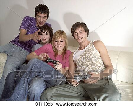 Stock Image - Teenagers playing computer games. Fotosearch