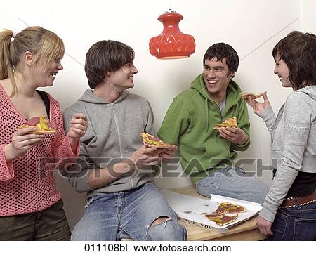 Stock Image - Teenagers sharing a pizza. Fotosearch