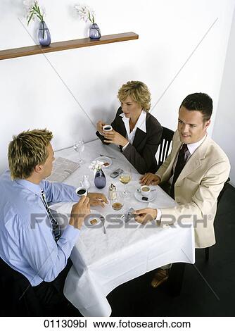 three business people at lunch, one holding a credit card View Large Photo Image Stock Image - three business people at lunch, one holding a credit card. Fotosearch