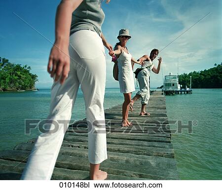 twens walking on pier View Large Photo Image Stock Image - twens walking on pier. Fotosearch