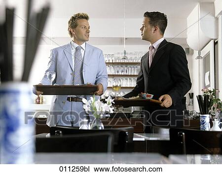 two businessman talking while holding their trays in a self-service restaurant View Large Photo Image Stock Image - two businessman talking while holding their trays in a self-service restaurant. Fotosearch