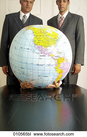 two businessmen looking at inflatable globe held by two hands View Large Photo Image Stock Image - two businessmen looking at inflatable globe held by two hands. Fotosearch