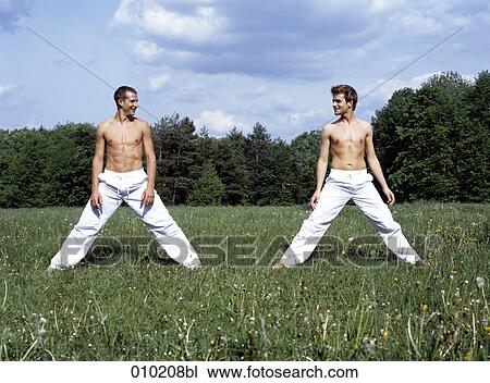 two gay men doing wellness exercises in park View Large Photo Image Stock Image - two gay men doing wellness exercises in park. Fotosearch