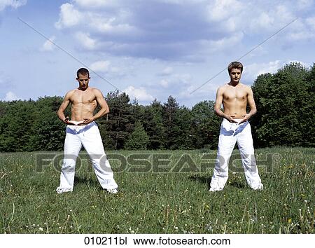 two gay men doing wellness exercises in park View Large Photo Image Stock Image - two gay men doing wellness exercises in park. Fotosearch