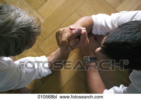 two men arm wrestling on the floor View Large Photo Image Stock Image - two men arm wrestling on the floor . Fotosearch