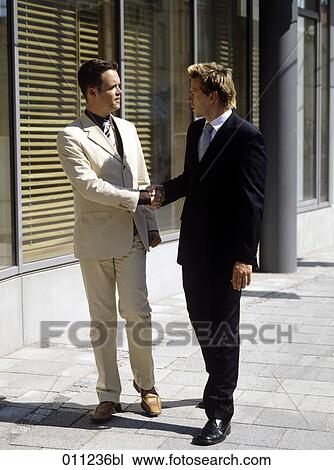 two men in business suits shaking hands View Large Photo Image Stock Image - two men in business suits shaking hands. Fotosearch
