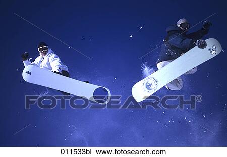 two people jumping with their snowboards View Large Photo Image Stock Image - two people jumping with their snowboards. Fotosearch