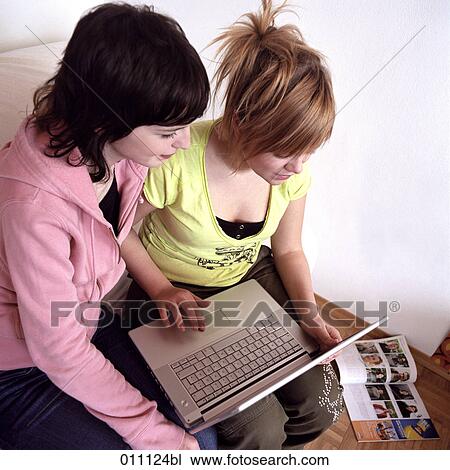 Two teenage girls working with laptop computer View Large Photo Image Stock Image - Two teenage girls working with laptop computer. Fotosearch