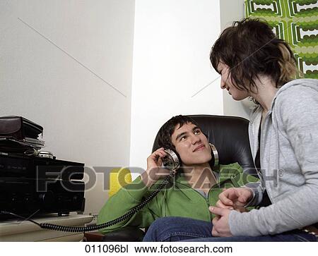 Two teenagers looking at each other while listening to records View Large Photo Image Stock Image - Two teenagers looking at each other while listening to records. Fotosearch