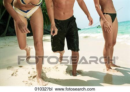 two women and one man playing on the beach View Large Photo Image Stock Image - two women and one man playing on the beach. Fotosearch
