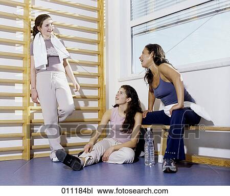 Woman and teenagers taking a break from physical exercises in gym View Large Photo Image Stock Image - Woman and teenagers taking a break from physical exercises in gym. Fotosearch