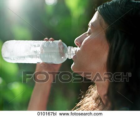 woman in bikini drinking water from plastic bottle View Large Photo Image Stock Image - woman in bikini drinking water from plastic bottle. Fotosearch