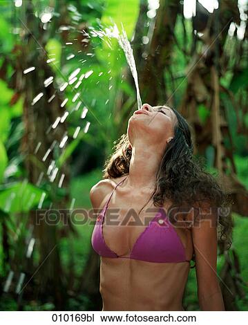 woman in bikini spitting out water View Large Photo Image Stock Image - woman in bikini spitting out water. Fotosearch