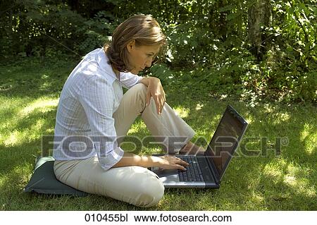 woman in her garden working with her laptop computer View Large Photo Image Stock Image - woman in her garden working with her laptop computer. Fotosearch