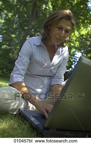 woman in her garden working with her laptop computer View Large Photo Image Stock Image - woman in her garden working with her laptop computer. Fotosearch