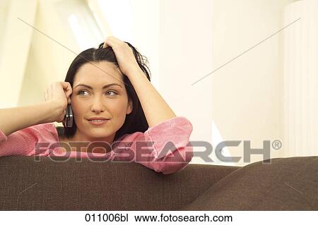 Woman in pink shirt using mobile phone View Large Photo Image Stock Image - Woman in pink shirt using mobile phone . Fotosearch