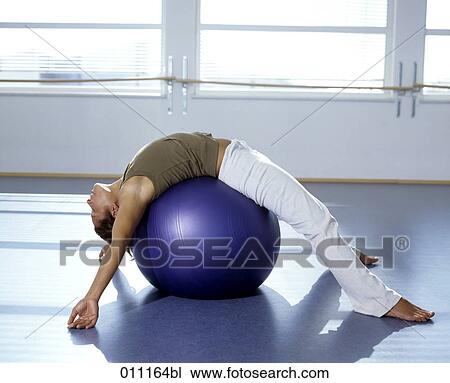 Woman lying on blue ball during pilates exercise View Large Photo Image Stock Image - Woman lying on blue ball during pilates exercise. Fotosearch