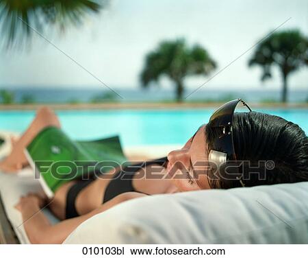 woman on deck chair sunbathing View Large Photo Image Stock Image - woman on deck chair sunbathing. Fotosearch