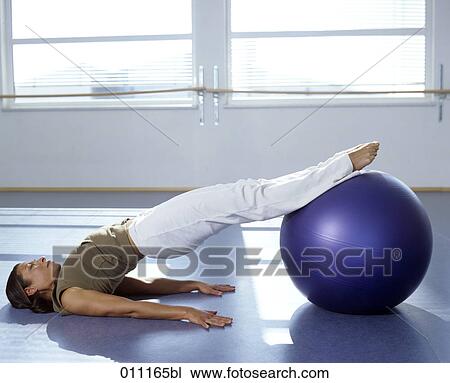 Woman performing pilates exercise in gym View Large Photo Image Stock Image - Woman performing pilates exercise in gym. Fotosearch
