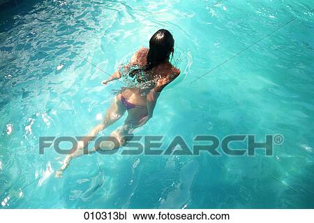 woman swimming in clear sea water View Large Photo Image Stock Image - woman swimming in clear sea water. Fotosearch