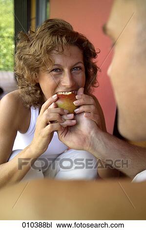 woman taking a bite from an apple View Large Photo Image Stock Image - woman taking a bite from an apple. Fotosearch