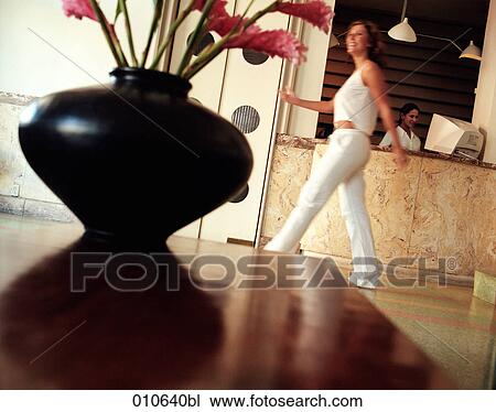 woman walking through hotel lobby View Large Photo Image Stock Image - woman walking through hotel lobby. Fotosearch