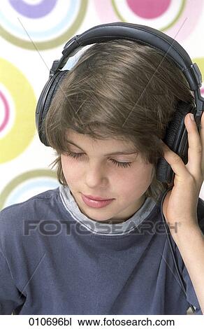 young boy wearing headphones listening to music View Large Photo Image Stock Image - young boy wearing headphones listening to music. Fotosearch