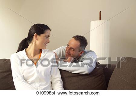 Stock Image - Young couple looking at each other. Fotosearch