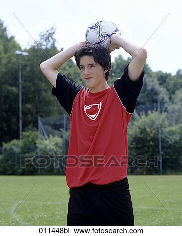 Stock Image - young football player doing a throw-in. Fotosearch