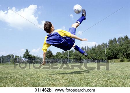 Stock Image - young footballer doing an overhead kick. Fotosearch