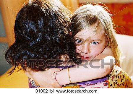 young girl in woman´s arms looking up to camera View Large Photo Image Stock Image - young girl in woman´s arms looking up to camera. Fotosearch