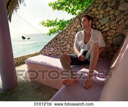 young man (25-30 years) relaxing on his veranda View Large Photo Image Stock Image - young man (25-30 years) relaxing on his veranda. Fotosearch