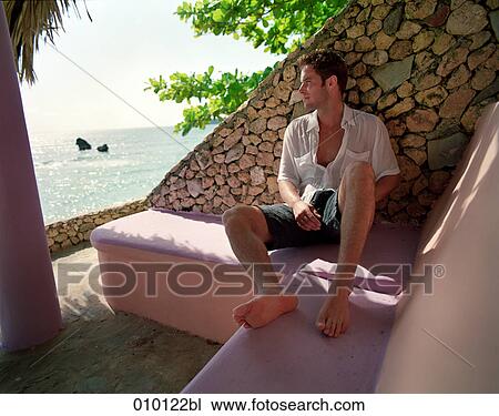 young man (25-30 years) relaxing on his veranda View Large Photo Image Stock Image - young man (25-30 years) relaxing on his veranda. Fotosearch